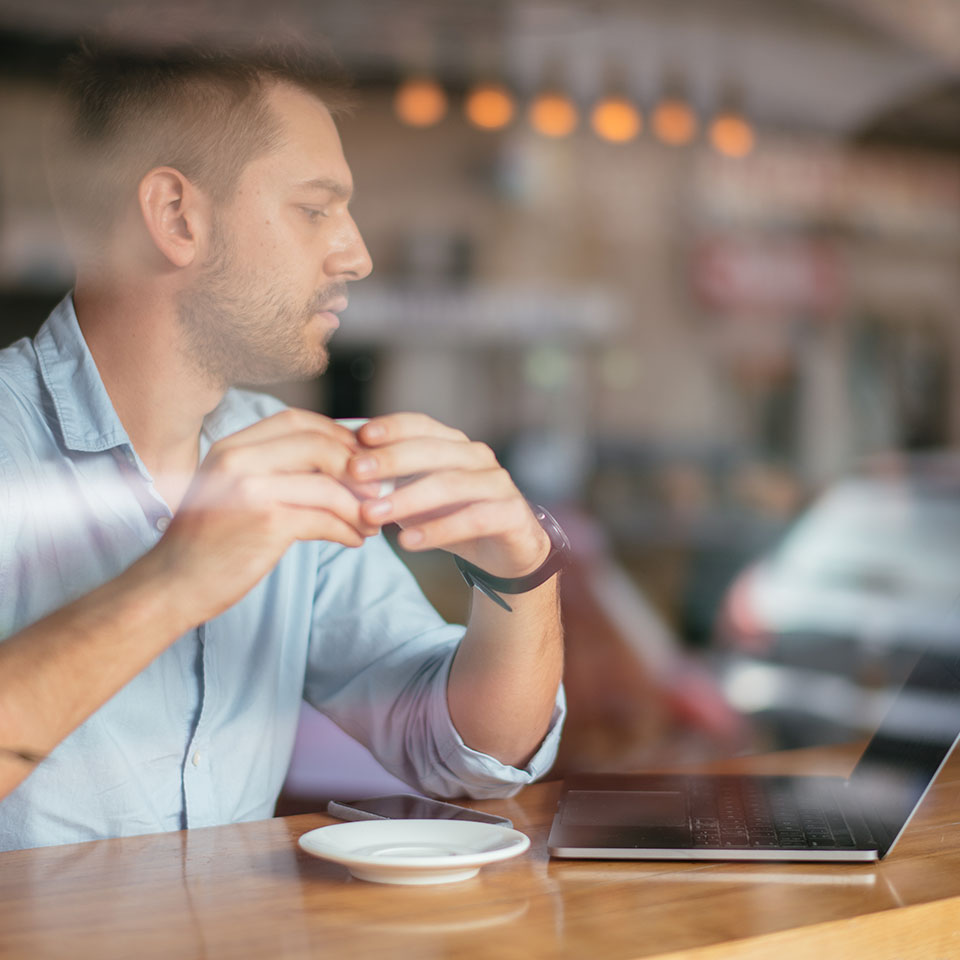 Businessman in cafe bar on a break drinking juice. Developed from RAW; retouched with special care and attention; Small amount of grain added for best final impression. 16 bit Adobe RGB color profile.